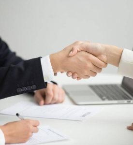 hr-handshaking-successful-candidate-getting-hired-new-job-closeup-min